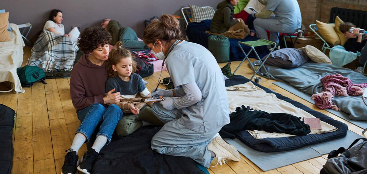 Nurses in homeless shelter doing check-ups.